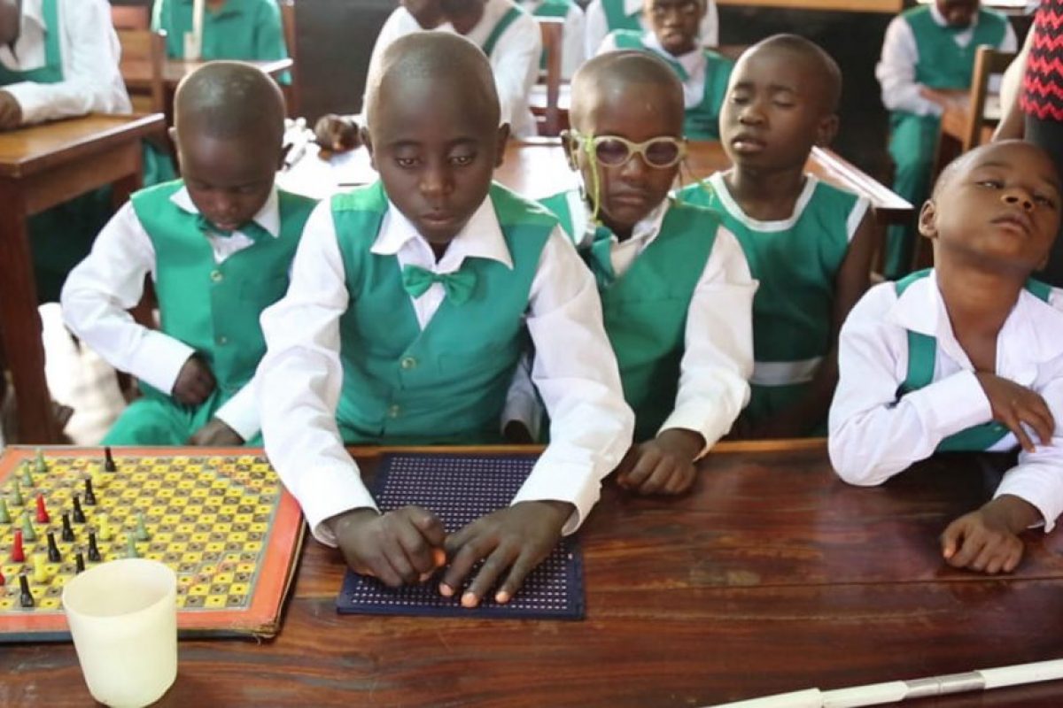 Children with visual impairment using braile to study
